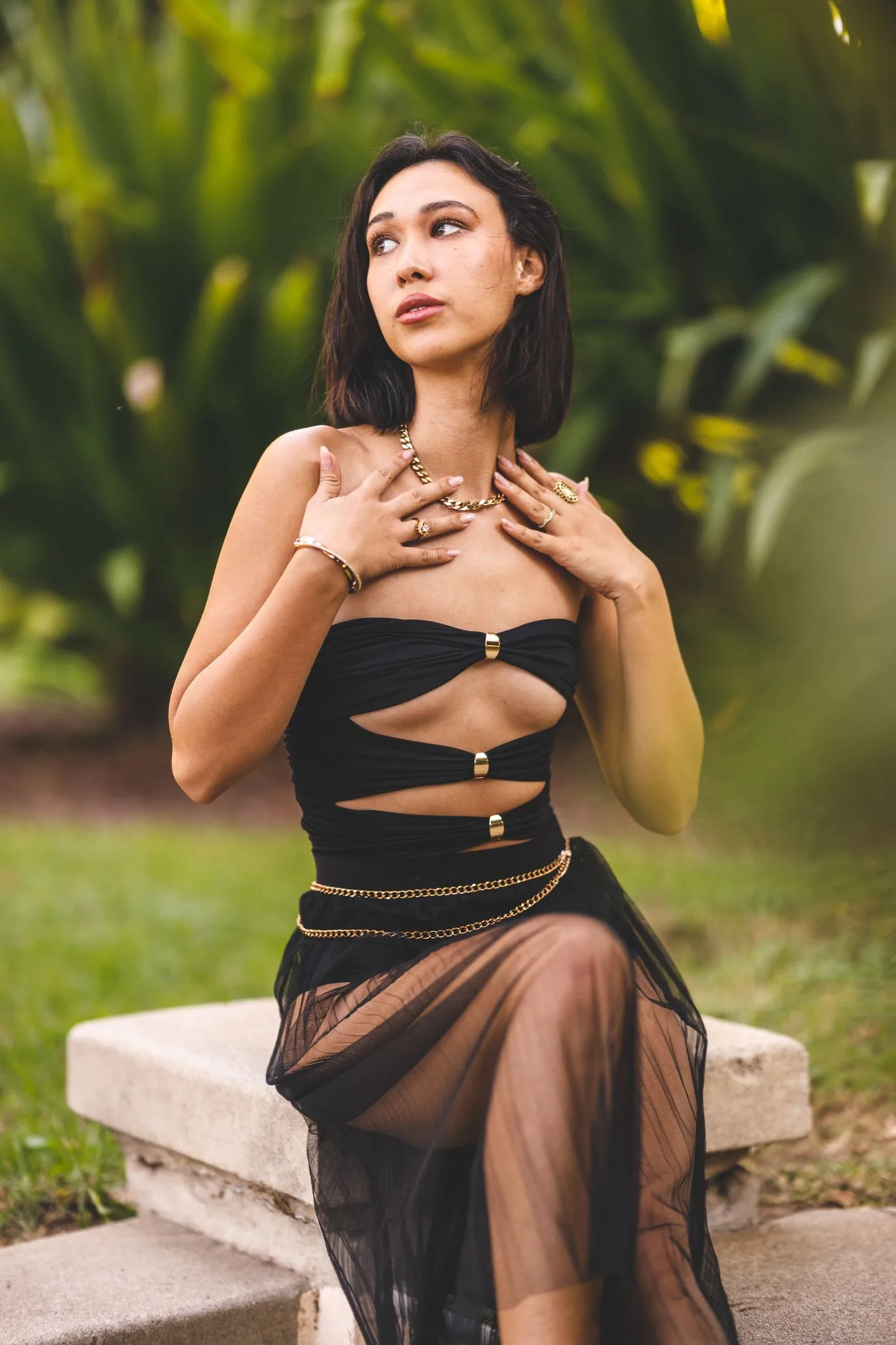 A woman in a black dress in a green garden