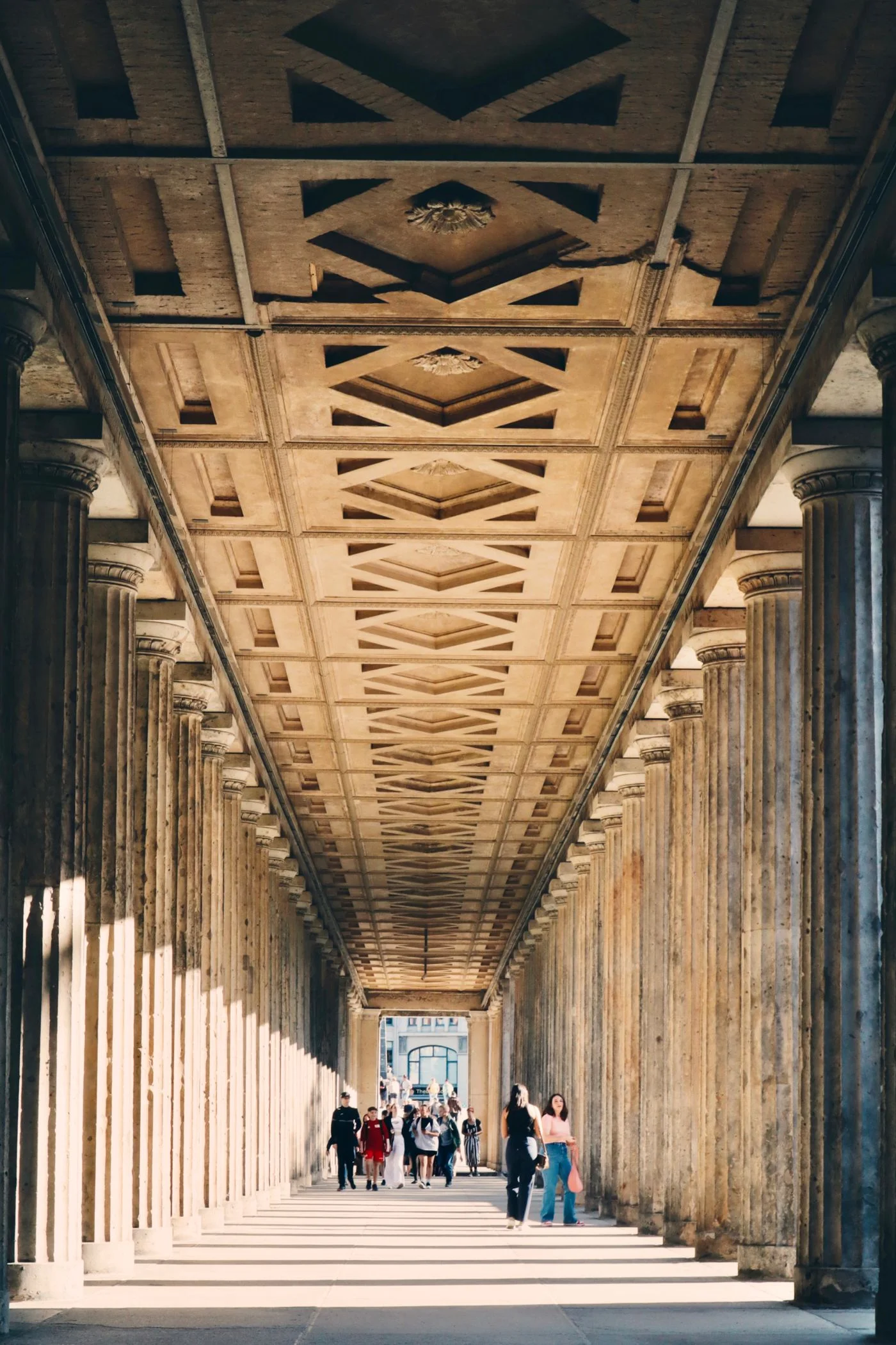 A stone colonnade with a coffered ceiling