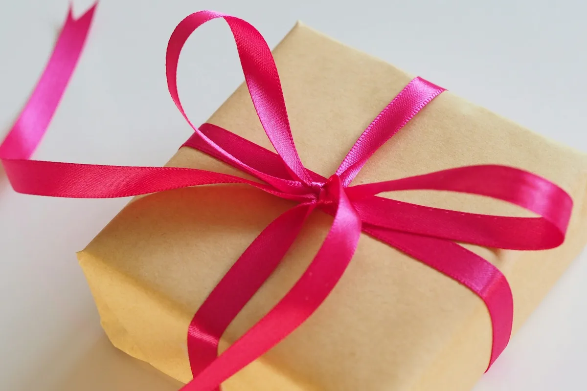 A wrapped parcel tied with a bright pink ribbon
