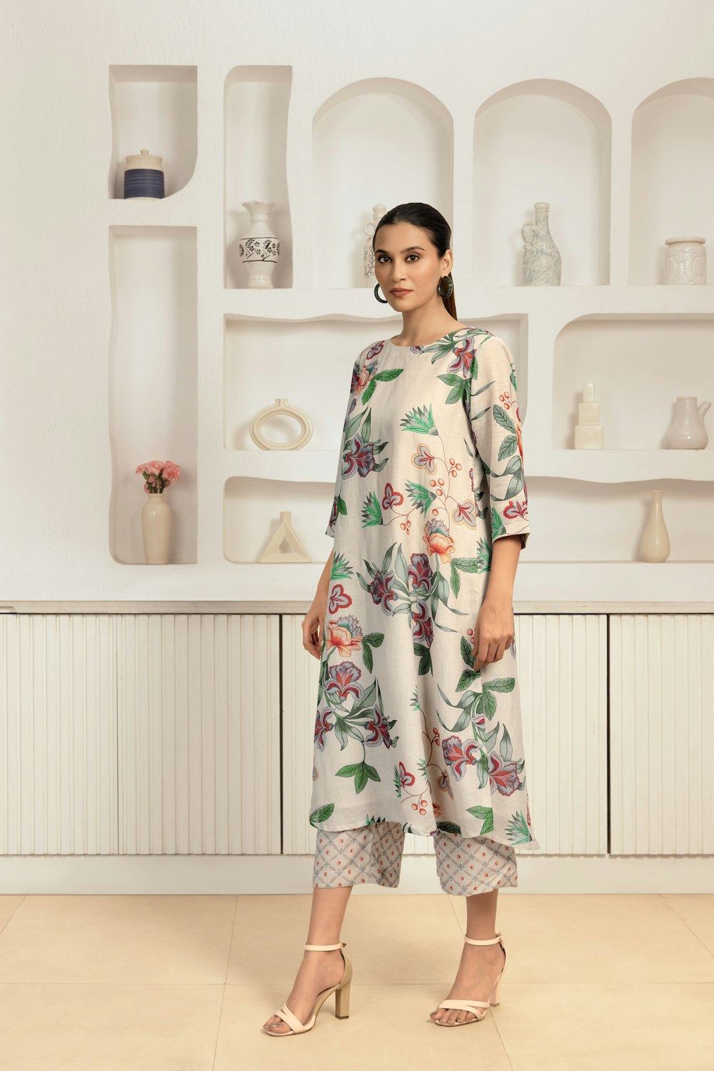 Woman wearing a floral dress in a bright room